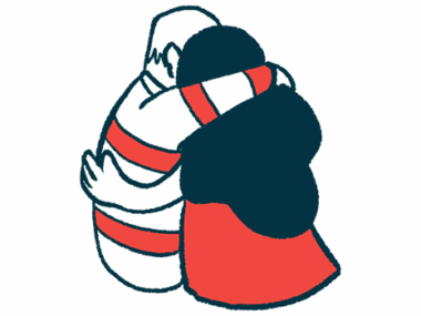 Two people engaged in a supportive hug are shown from the back.