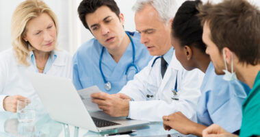 A team of healthcare specialists looking at a patient's chart