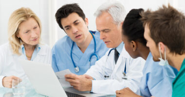 A team of healthcare specialists looking at a patient's chart