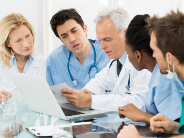 A team of healthcare specialists looking at a patient's chart