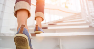 a close-up of a woman's feet as she walks up steps