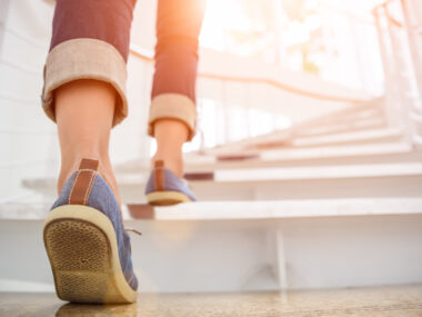 a close-up of a woman's feet as she walks up steps
