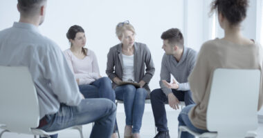 a support group sitting in a circle in chairs