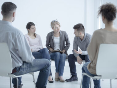 a support group sitting in a circle in chairs