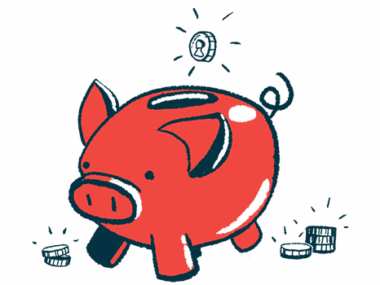 A coin is seen dropping into the top slot of a pig-shaped bank.