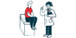 A clinician speaks to a patient who's sitting on the end of an examination table.