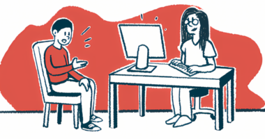 A doctor sits at a desk talking to a patient.