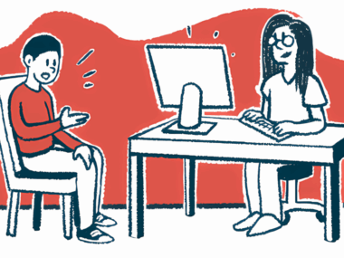 A doctor sits at a desk talking to a patient.