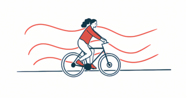 An illustration of a female exercising by riding a bike.