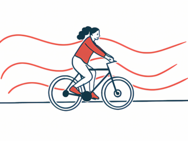 An illustration of a female exercising by riding a bike.