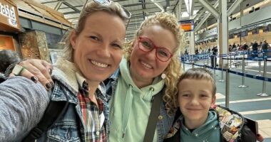 Two women and a young boy are seen in a selfie taken by one of the adults.