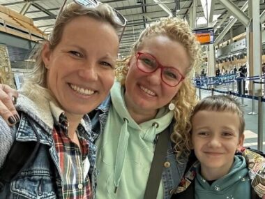 Two women and a young boy are seen in a selfie taken by one of the adults.